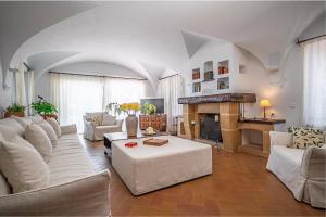 a living room with white furniture and a fireplace at Torre Sant Genís in Llança