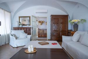 a living room with a white couch and a table at Torre Sant Genís in Llança +27 photos