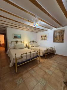 a bedroom with two beds in a room at Cortijo Mainacio in Siles