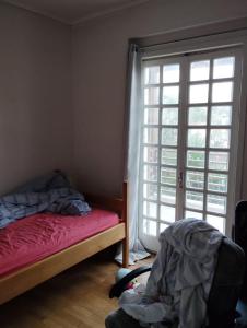 a bedroom with a bed and a large window at Leo House in Selínia