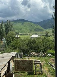 a view of a farm with mountains in the background at Altyn-Bulak in Kemin +10 photos
