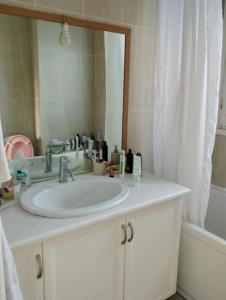 a bathroom with a white sink and a mirror at Leo House in Selínia +16 photos