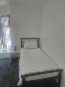 a small bed in a room with a window at Waterloo apartment in Middlesbrough