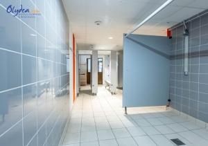 an empty hallway of an office building with a blue door at Olydea les Bottieres - Saint-Pancrace in Saint-Pancrace
