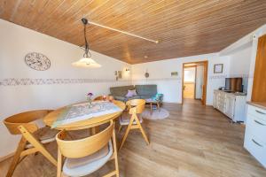 a kitchen and living room with a table and chairs at Steffi's Landhof in Bad Wörishofen