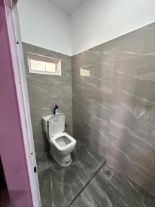 a bathroom with a white toilet in a room at JB Vin Hotel in Point Pedro