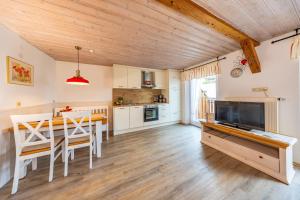 a kitchen and dining room with a table and a television at Steffi's Landhof in Bad Wörishofen