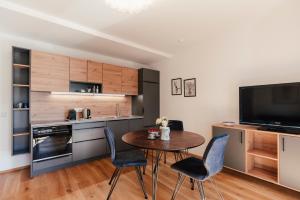 a kitchen and dining room with a table and chairs at Echo am See in Gmunden