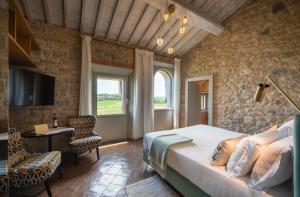 a bedroom with a bed and a tv in a room at Locanda dei Logi in San Gimignano +113 photos