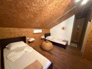 a bedroom with a bed and a bathroom with a shower at Blue Eye Villas in Sarandë