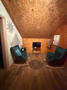 a living room with two chairs and a fireplace at Blue Eye Villas in Sarandë +33 photos