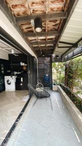a porch with a hammock in a house at Bedsment in Chiang Rai