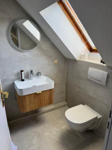 a bathroom with a sink and a toilet at Parkhotel am Schloss Machern in Machern +34 photos
