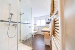 a bathroom with a shower and a toilet and a sink at Steffi's Landhof in Bad Wörishofen +10 photos