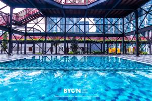 a swimming pool in a building with blue water at Geo38 Premium Suites Genting Highlands by BYON in Genting Highlands