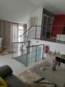 a living room with a staircase and a table at cupido feeling nomad in Souro Pires