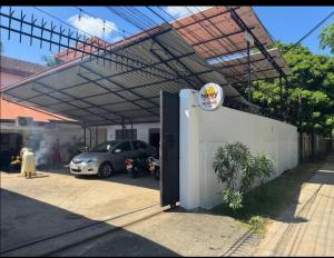 a parking lot with a car parked under a roof at Honey guest Batticaloa in Batticaloa
