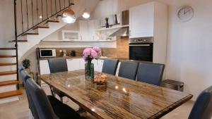 a dining room table with chairs and a vase of flowers at Residence Panorama in Buzet +8 photos