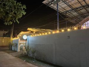 a building with lights on a wall at night at Honey guest Batticaloa in Batticaloa