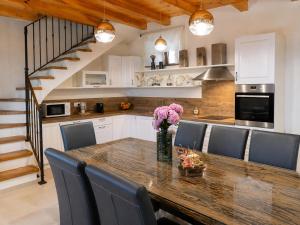 a kitchen with a wooden table with a vase of flowers at Residence Panorama in Buzet