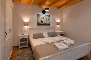 a bedroom with a bed with white sheets and pillows at Residence Panorama in Buzet