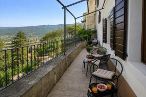 a balcony with two chairs and a view at Residence Panorama in Buzet