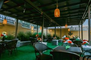 a restaurant with tables and chairs and flowers on the wall at Neriah Suites in Kabale