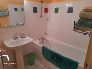 a bathroom with a sink and a toilet and a tub and a sink at Chambres d'hôtes de charme "La Tour Richelieu" in Martres-de-Veyre