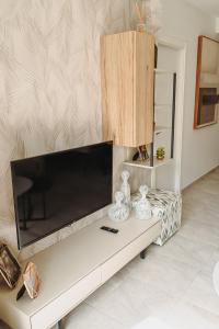 a living room with a large flat screen tv at Xava Dreams Aire in Villacosta