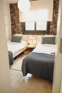 a bedroom with two beds and a window at Xava Dreams Aire in Villacosta +30 photos