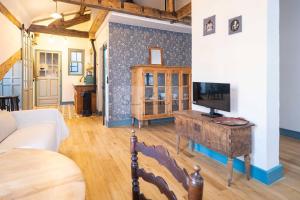 a living room with a couch and a tv on a table at Sol By Silastur in Villaviciosa
