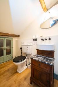 a bathroom with a toilet and a sink and a mirror at Sol By Silastur in Villaviciosa +28 photos