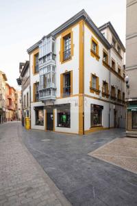 a large yellow and white building on a street at Sol By Silastur in Villaviciosa