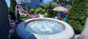 an outdoor water park with a tub of water at Casa Izabela in Năvodari
