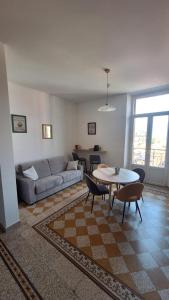 a living room with a couch and a table and chairs at Casa Tatta - Luino centro in Luino