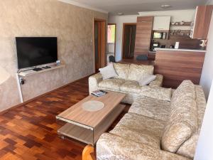 a living room with a couch and a table at Contact Apartman in Bardejov