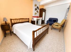 a bedroom with a bed and a chair and a desk at La maison boîte à gâteaux in Lapalme