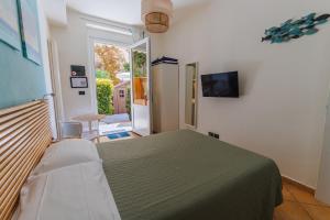 a bedroom with a bed and a door to a patio at Soffio Di Mare in Camogli