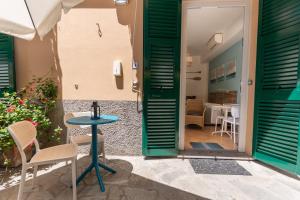 a door leading to a patio with a table and chairs at Soffio Di Mare in Camogli