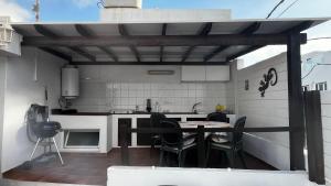 a kitchen with a table and chairs in a kitchen at Maison bord de mer Calypso in Punta Mujeres