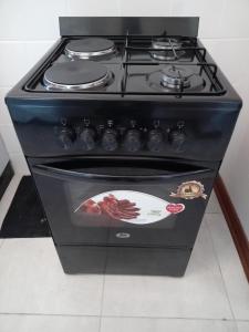 a black stove top oven sitting in a kitchen at M's guest place Nata in Nata +4 photos