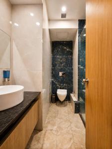 a bathroom with a sink and a toilet at Soho Suites in Bedla