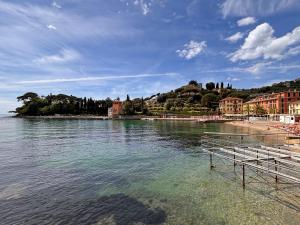 a body of water with a beach and buildings at Villa Viola in Rapallo