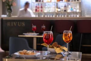two glasses of wine on a table in a restaurant at Palazzo De Polo in Venice +80 photos