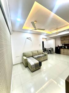 a living room with a couch in the middle at Cozy 2BHK with Balcony & Kitchen in Nagpur