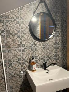a bathroom with a white sink and a mirror at TINY HOUSE domek do wynajęcia in Olsztyn +17 photos
