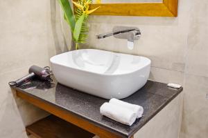 a white sink on a counter in a bathroom at Darlina Hiriketiya in Hiriketiya +40 photos