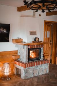 a stone fireplace in a living room with a fire place at U Hani in Bańska Wyżna