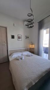 a bedroom with a bed with two towels on it at The Suite in Kavála