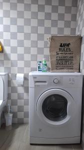 a washing machine with a box on top of it in a bathroom at The Suite in Kavála